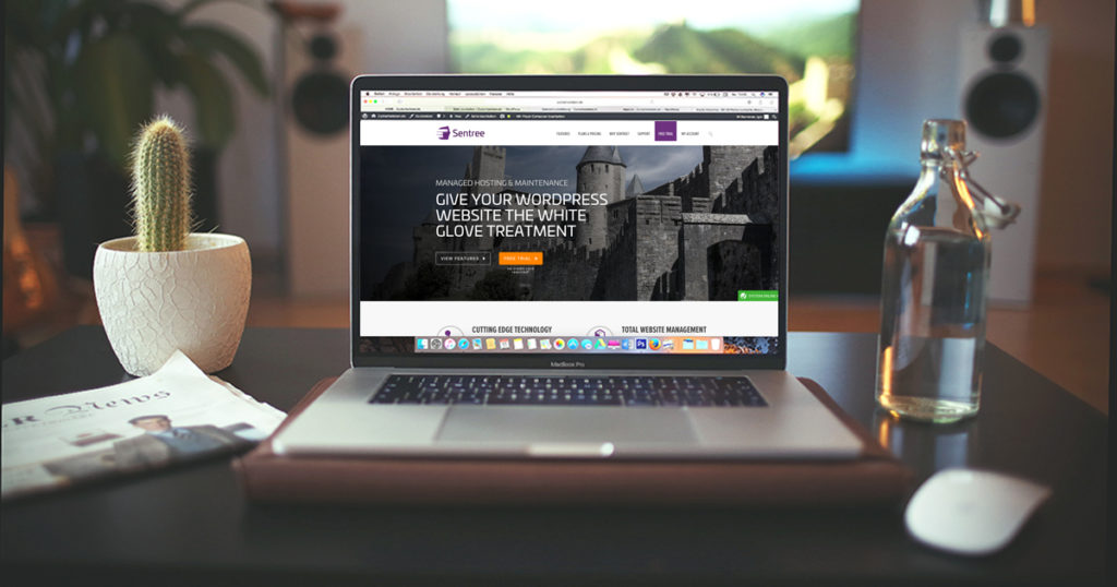 Laptop open on a desk displaying the Sentree.io website (and yes, our site is up to date)